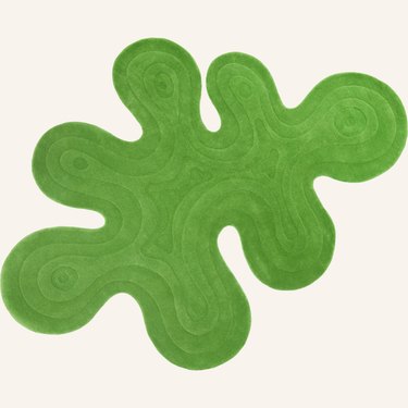 A bright green blob-shaped rug