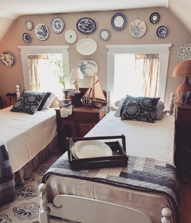 blue and white plates above windows and beds