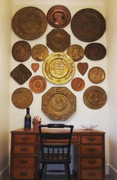 brass plate wall above wood desk