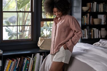 woman wearing linen loungewear in bedroom