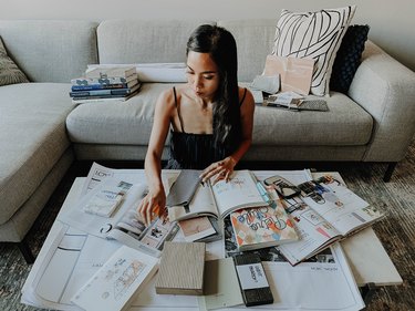 Lauren Reyes Lim working at coffee table with materials and couch in the background