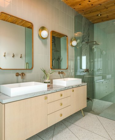 midcentury modern bathroom design with wood vanity and terrazzo flooring