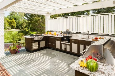 outdoor kitchen under white awningtrell