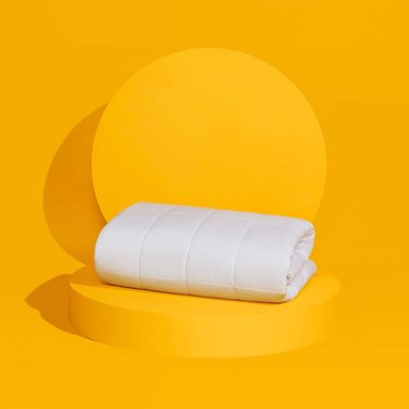 Slumber Cloud lightweight comforter on yellow background
