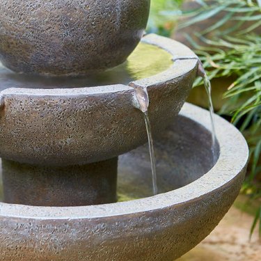 Close-up view of water trickling from a garden fountain