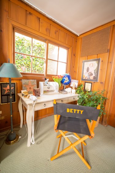 The inside of White's Carmel, CA, home with director's chair and desk