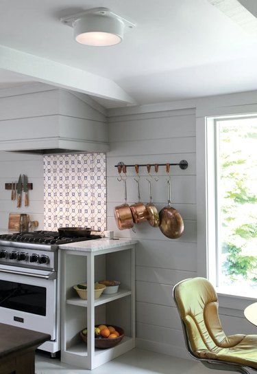 all white kitchen with sleek flush mount light fixture