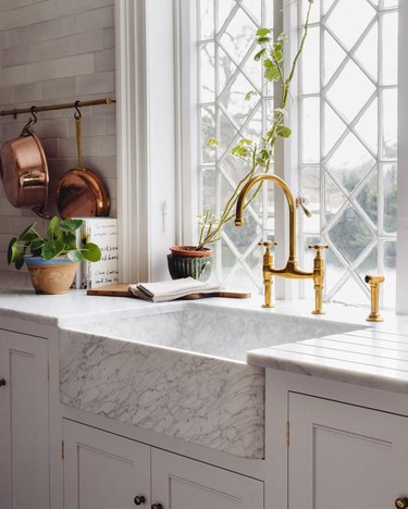 marble kitchen sink with brass fixtures in vintage kitchen