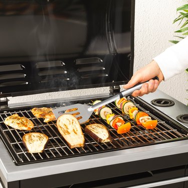 person using spatula on grill with food