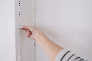 Removing shelf bracket clip from shelving track