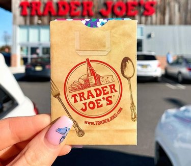 Hand holding Trader Joe's gift card