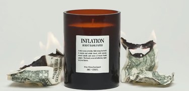 Inflation Candle next to burning dollar bills