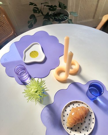overhead photo of a table with purple placemats and dishes