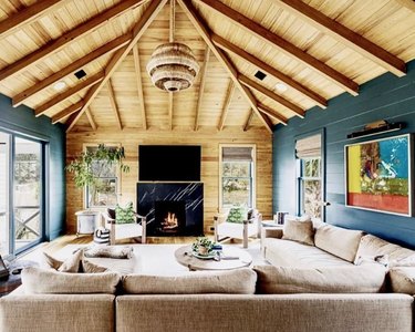 living room with wood and teal walls