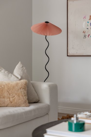 living room with Oscar Piccolo lamp sitting alongside white sofa