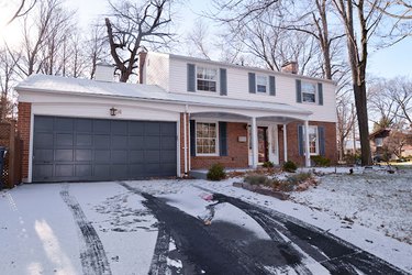 A 1970s colonial revival center hall exterior in the snow