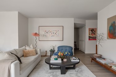 The open plan living room with neutral palette and pops of bright accent colors