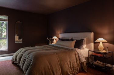 moody bedroom with dark painted walls and ceiling