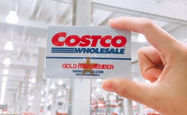 Hand holding Costco membership card