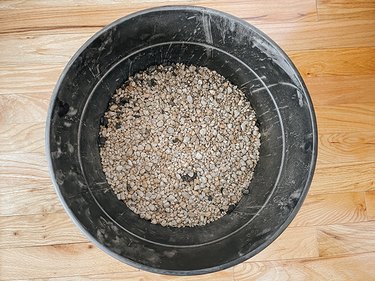 Fill the bottom of a pot with pea gravel.