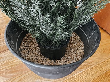 Set the plant on top of the pea gravel in the pot.