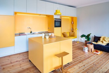 kitchen with yellow and pale blue cabinetry and blue and yellow accents
