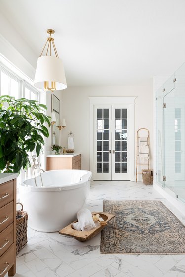 white traditional bathroom with brass light fixtures and white lampshades