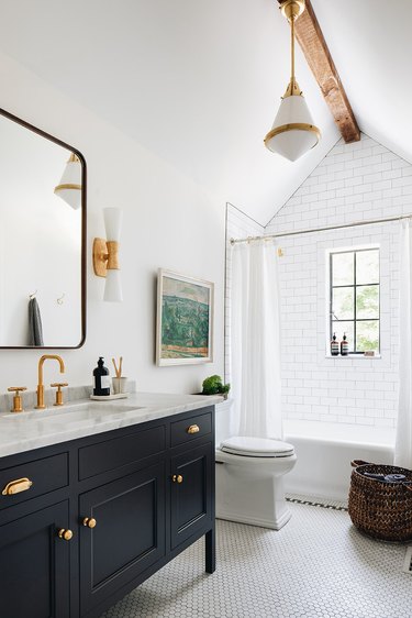 modern white and brass pendant light in traditional bathroom