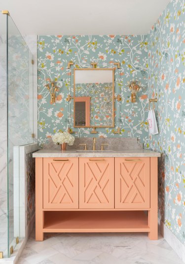 A sherbet and pale blue bathroom with white tile floor