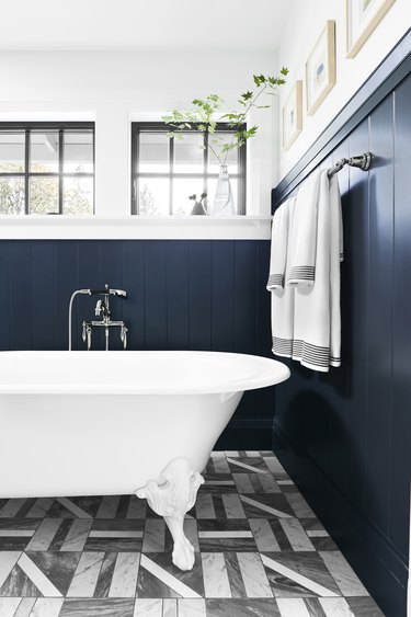 Navy wall in black and white bathroom
