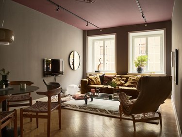 mauve ceiling with gray walls and mustard yellow sofa
