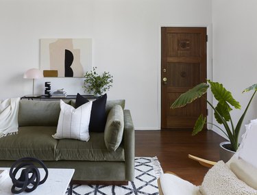 black color goes with sage green sofa in living room