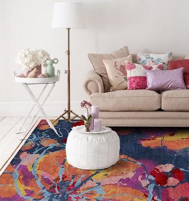 living room with plush ottoman and rug