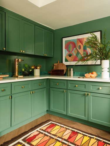 green kitchen with jewel color rug
