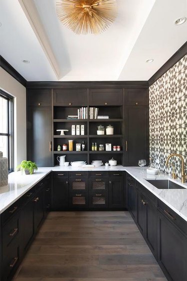 kitchen with brown cabinets and brown patterned walls