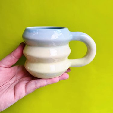 A rounded mug with a gradient glaze from the ceramics maker Mud Witch.