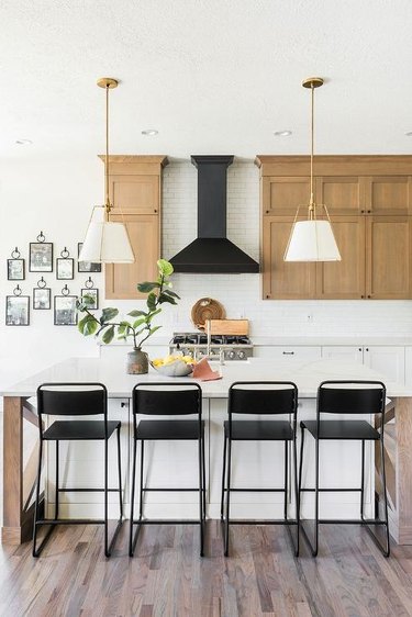kitchen with light brown cabinets and black accents