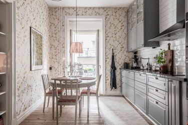 gray kitchen cabinets with beige floral wallpaper