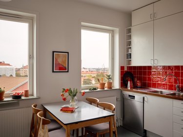 gray kitchen cabinets with red tile backsplash