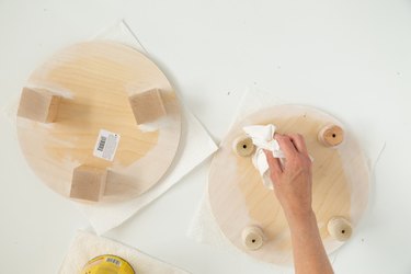 Hand wiping stain from DIY wood plant riser