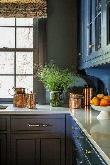 kitchen with gray walls and blue cabinets