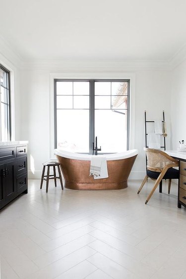 white bathroom with copper bathtub