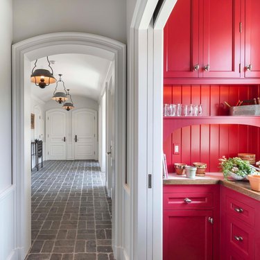 kitchen with gray walls and red cabinets
