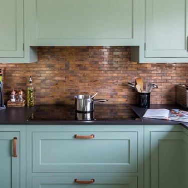 kitchen with copper backsplash and turquoise cabinets