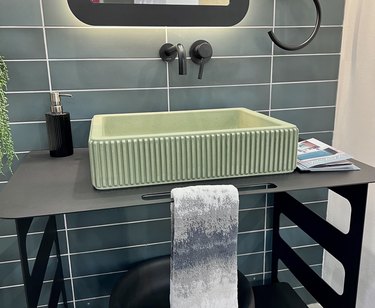 Lacava fluted concrete sink on top of black vanity at ICFF 2023