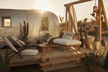h&m home glamping collection next to airstream in desert