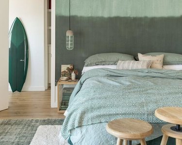 room with seafoam green duvet and accents in other shades of green