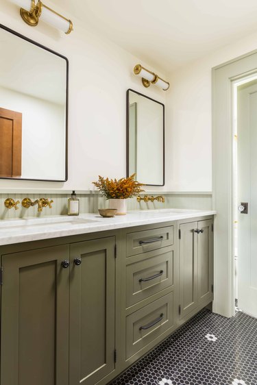 traditional bathroom backsplash with green cabinets