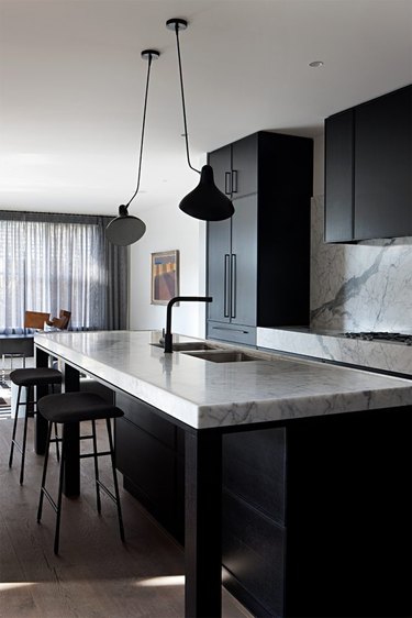 black monochromatic kitchen with marble countertops