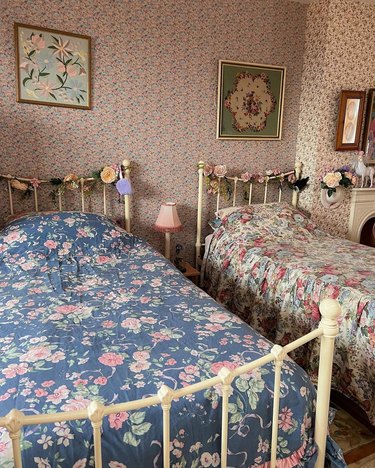 bedroom with two twin beds covered in floral quilts